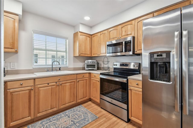 3205 W De Leon St Unit F, Tampa, FL 33609 - kitchen with stainless steel appliances, a sink, light wood-style flooring, light countertops, and recessed lighting