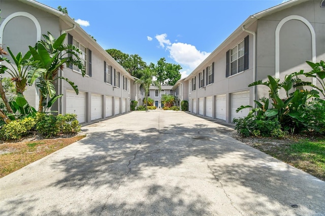 3205 W De Leon St Unit F, Tampa, FL 33609 - view of concrete surface featuring community garages and a residential view