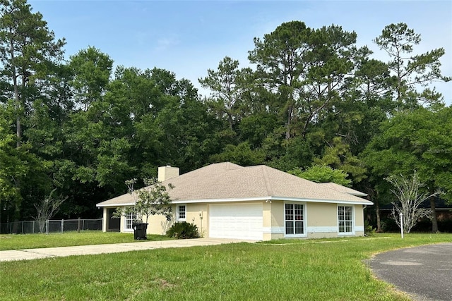 607 NE 10th Blvd, Williston, FL 32696 - single story home with driveway, a garage, a chimney, and stucco siding