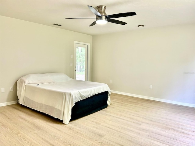 607 NE 10th Blvd, Williston, FL 32696 - bedroom with light wood-style floors, baseboards, access to exterior, and a ceiling fan