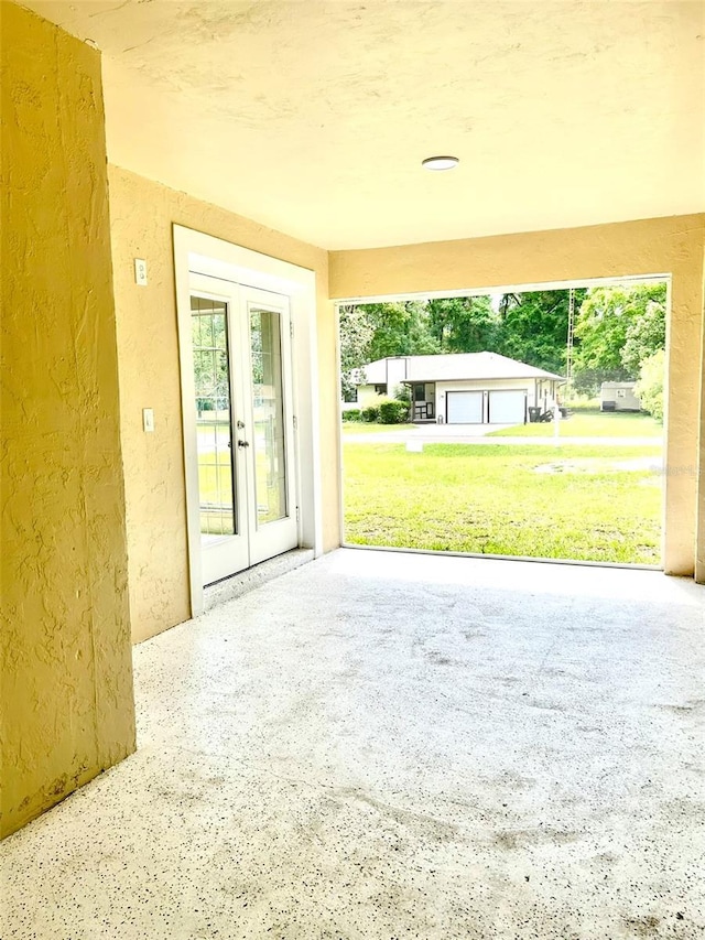 607 NE 10th Blvd, Williston, FL 32696 - doorway to outside with a textured wall, healthy amount of natural light, and french doors