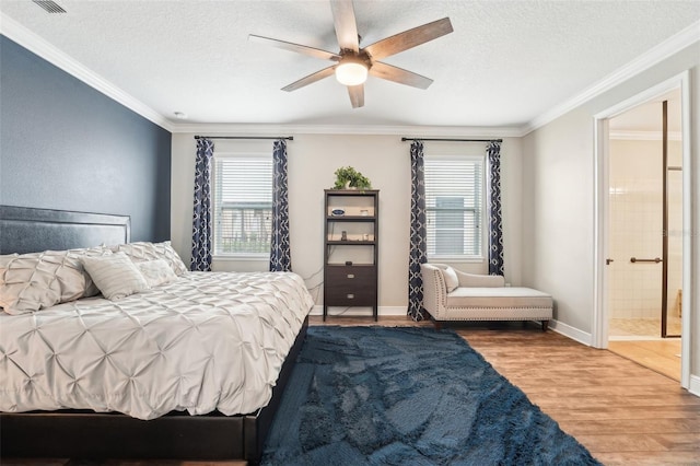 bedroom with multiple windows, wood finished floors, ornamental molding, a textured ceiling, and connected bathroom
