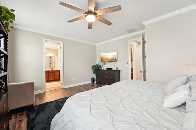 bedroom with wood finished floors, crown molding, baseboards, a ceiling fan, and ensuite bathroom