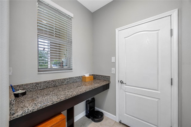 bathroom with tile patterned floors and baseboards