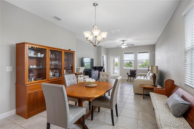 dining area with a chandelier, ceiling fan, light tile patterned floors, and baseboards