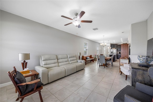 living room with a chandelier, a ceiling fan, and light tile patterned floors
