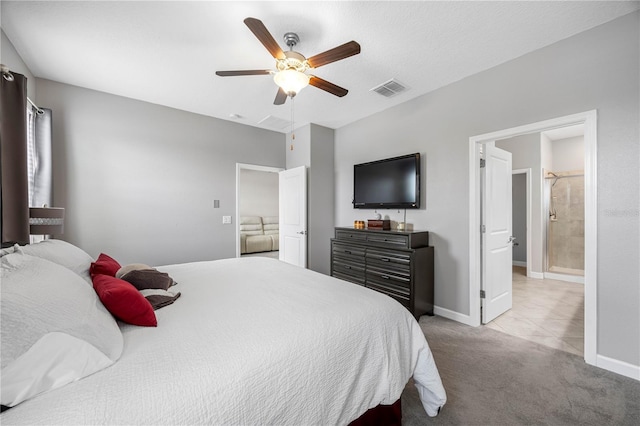 bedroom with carpet flooring, baseboards, ceiling fan, and connected bathroom