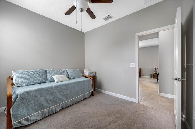 carpeted bedroom with tile patterned flooring, baseboards, and a ceiling fan
