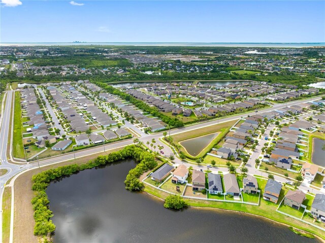 aerial overview of property's location with a large body of water and nearby suburban area