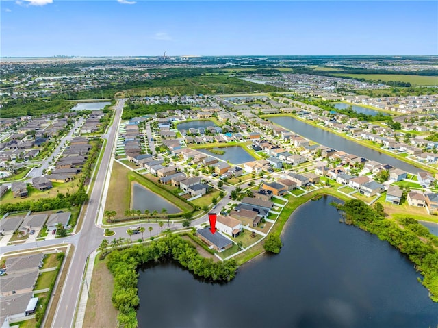 aerial view of property's location with nearby suburban area and a nearby body of water