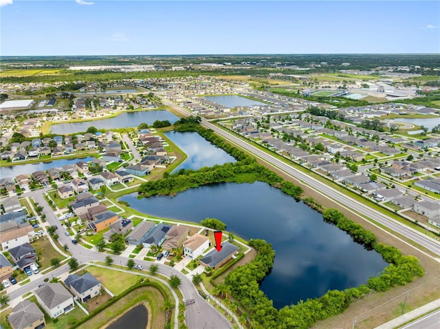 view of property location with a nearby body of water and nearby suburban area