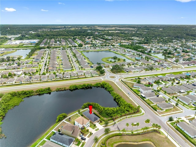 aerial overview of property's location featuring a large body of water and nearby suburban area