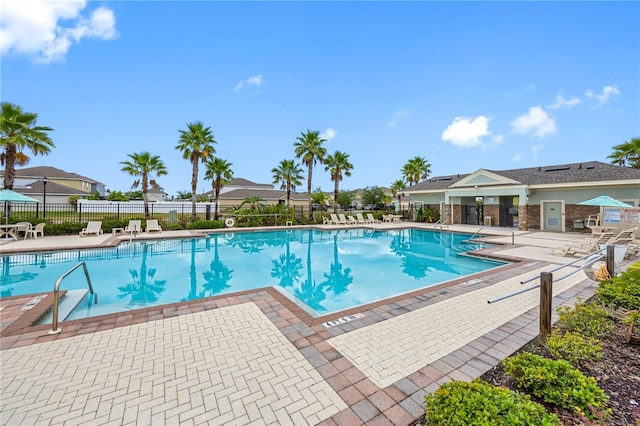 community pool featuring a patio area and fence