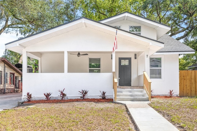 7 Hamilton Heath Dr, Tampa, FL 33604 - bungalow-style home with a shingled roof, fence, ceiling fan, and stucco siding