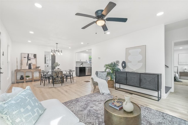 7 Hamilton Heath Dr, Tampa, FL 33604 - living room featuring light wood-style flooring, recessed lighting, a chandelier, ceiling fan, and baseboards