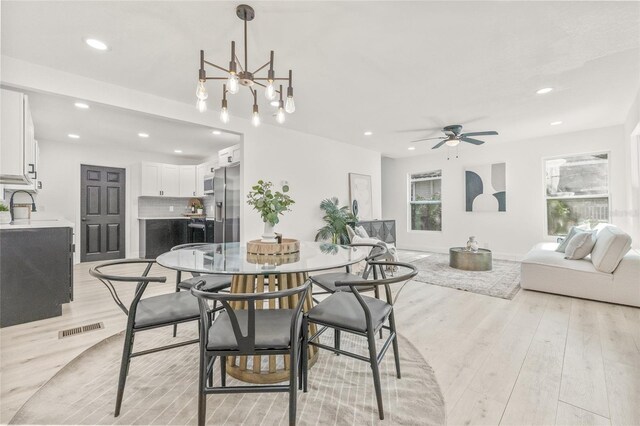 7 Hamilton Heath Dr, Tampa, FL 33604 - dining area with light wood-type flooring, recessed lighting, a chandelier, and ceiling fan