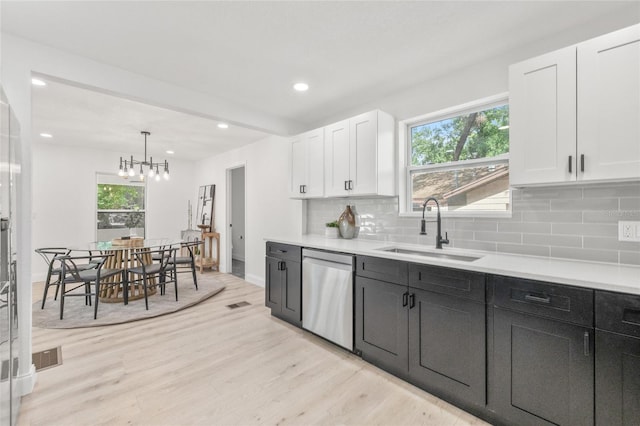 7 Hamilton Heath Dr, Tampa, FL 33604 - kitchen featuring dishwasher, a sink, white cabinetry, decorative backsplash, and recessed lighting