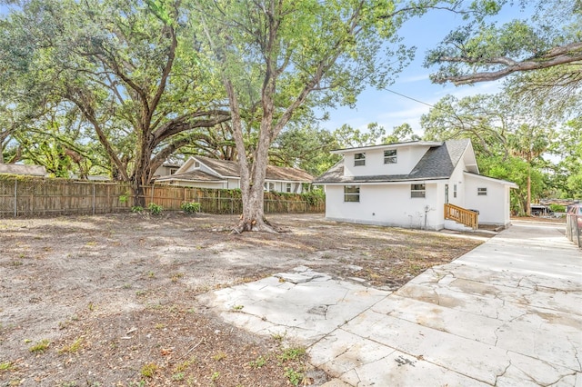 7 Hamilton Heath Dr, Tampa, FL 33604 - rear view of house featuring a patio area, roof with shingles, and stucco siding