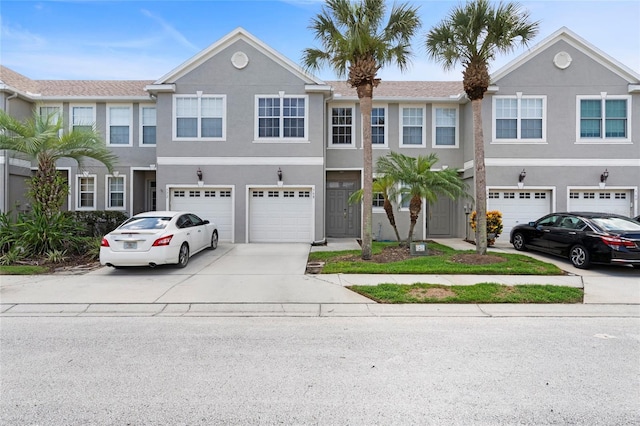 568 Shoreham Ct NE, Saint Petersburg, FL 33716 - multi unit property with driveway, a garage, and stucco siding