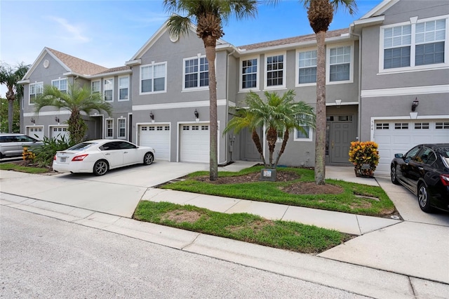 568 Shoreham Ct NE, Saint Petersburg, FL 33716 - townhome / multi-family property featuring concrete driveway, stucco siding, and an attached garage