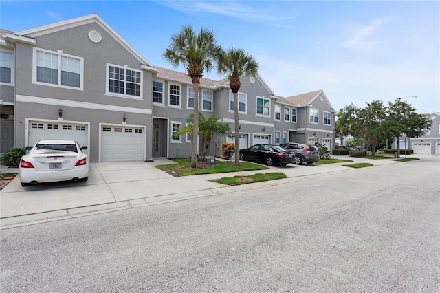 568 Shoreham Ct NE, Saint Petersburg, FL 33716 - view of property with driveway, a residential view, a garage, and stucco siding