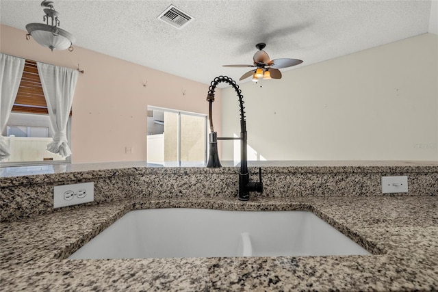 568 Shoreham Ct NE, Saint Petersburg, FL 33716 - kitchen view of a sink, ceiling fan, and a textured ceiling