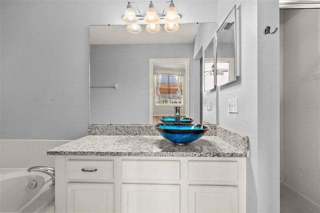 568 Shoreham Ct NE, Saint Petersburg, FL 33716 - full bathroom featuring a chandelier, vanity, and a bath