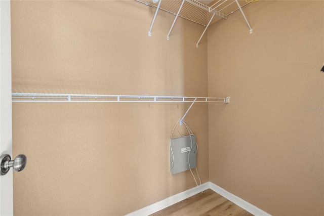 568 Shoreham Ct NE, Saint Petersburg, FL 33716 - walk in closet featuring wood finished floors