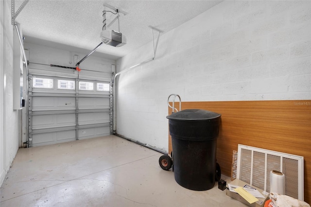 568 Shoreham Ct NE, Saint Petersburg, FL 33716 - garage featuring a garage door opener and concrete block wall