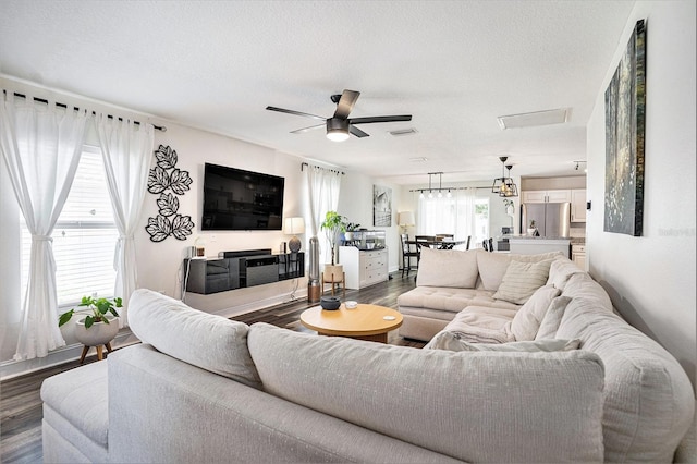 living room featuring dark wood-style floors and a ceiling fan