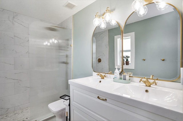 full bath featuring toilet, a walk in shower, and double vanity