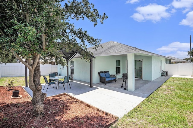 back of property with a patio area and roof with shingles