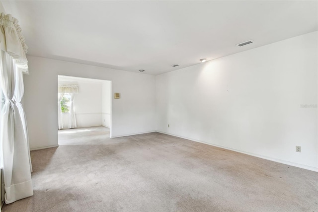 empty room with light carpet and baseboards