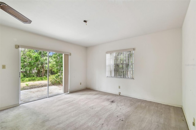 carpeted empty room with baseboards