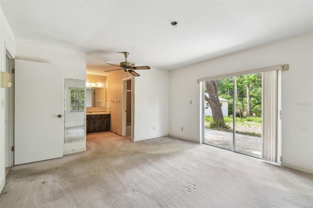 unfurnished living room featuring a ceiling fan, carpet floors, and baseboards
