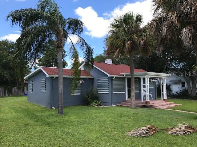 3007 Clinton St S, Gulfport, FL 33707 - ranch-style house featuring covered porch, a front lawn, and stucco siding