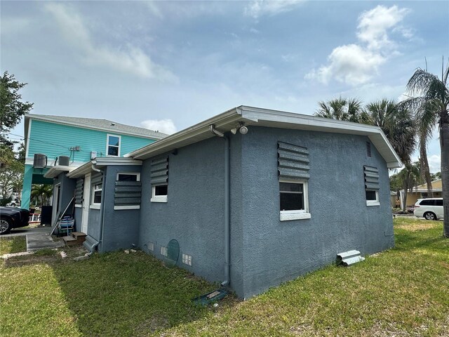 3007 Clinton St S, Gulfport, FL 33707 - view of property exterior with stucco siding and a yard