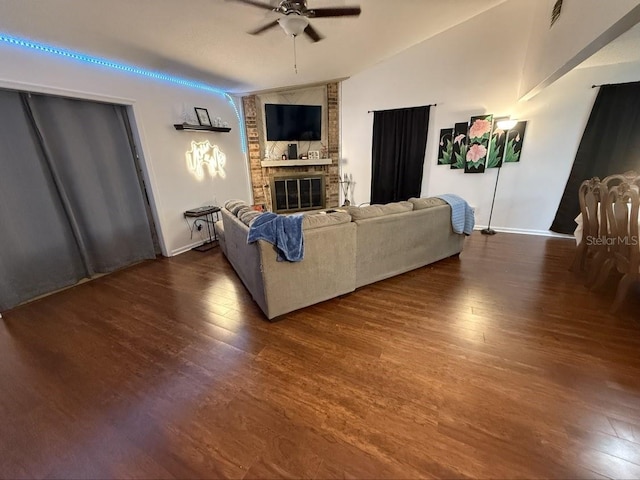 35058 Whispering Oaks Blvd, Dade City, FL 33523 - living room featuring ceiling fan, wood finished floors, a brick fireplace, baseboards, and lofted ceiling