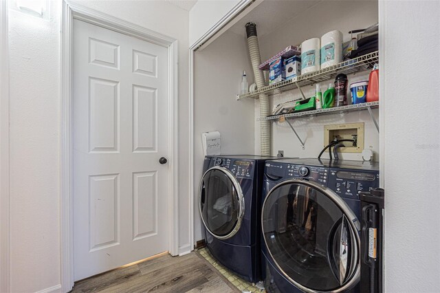 35058 Whispering Oaks Blvd, Dade City, FL 33523 - laundry area featuring washer and clothes dryer and wood finished floors