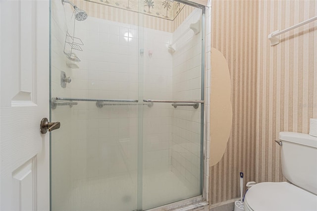 35058 Whispering Oaks Blvd, Dade City, FL 33523 - bathroom with wallpapered walls, toilet, and a stall shower