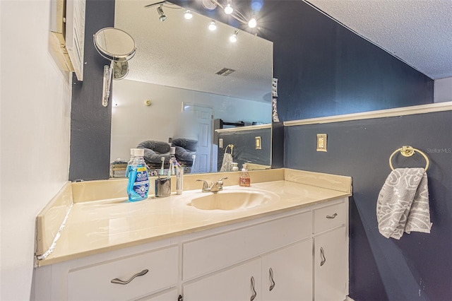 35058 Whispering Oaks Blvd, Dade City, FL 33523 - bathroom featuring a textured ceiling and vanity