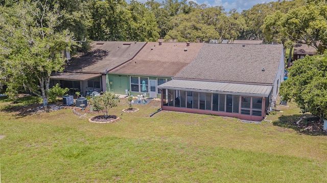 35058 Whispering Oaks Blvd, Dade City, FL 33523 - back of house featuring a sunroom, a yard, and roof with shingles