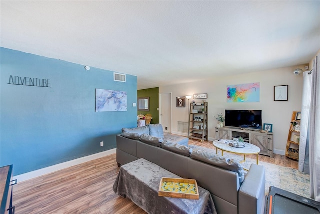 living area featuring wood finished floors and baseboards