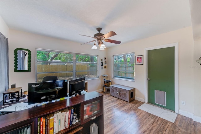 office space with ceiling fan, wood finished floors, and baseboards