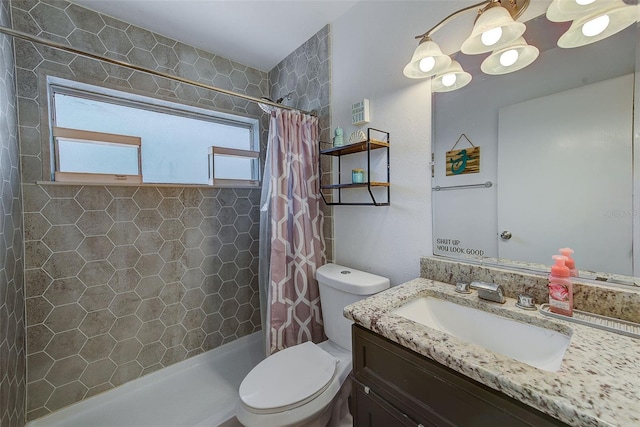 bathroom with toilet, a tile shower, and vanity