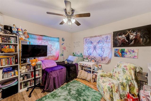 bedroom featuring wood finished floors and a ceiling fan