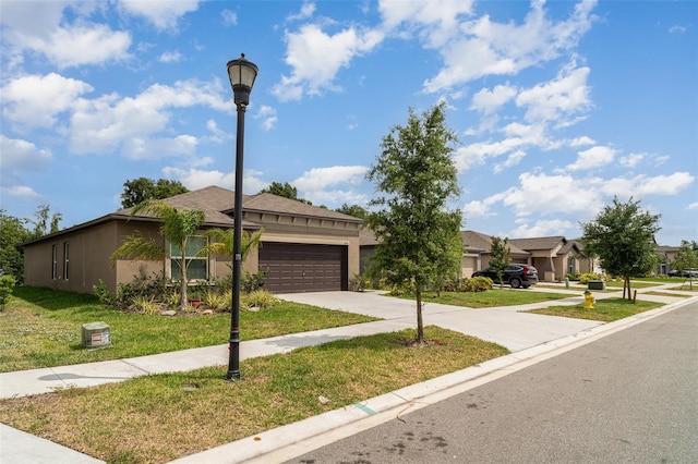 view of front of home featuring an attached garage, a front yard, and concrete driveway