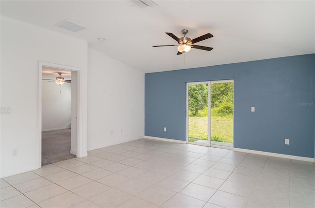 empty room featuring a ceiling fan, light tile patterned floors, and baseboards