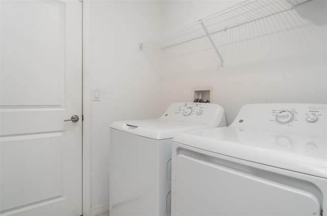 clothes washing area featuring independent washer and dryer
