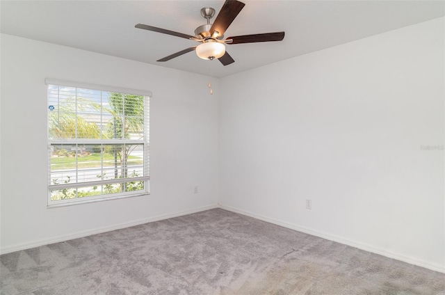 spare room with ceiling fan, carpet flooring, and baseboards